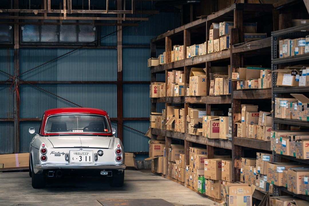 A vehicle in a parts warehouse with organized shelving of catalogued components