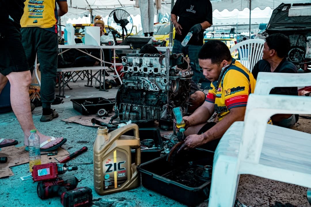Technician repairing a used engine block surrounded by tools