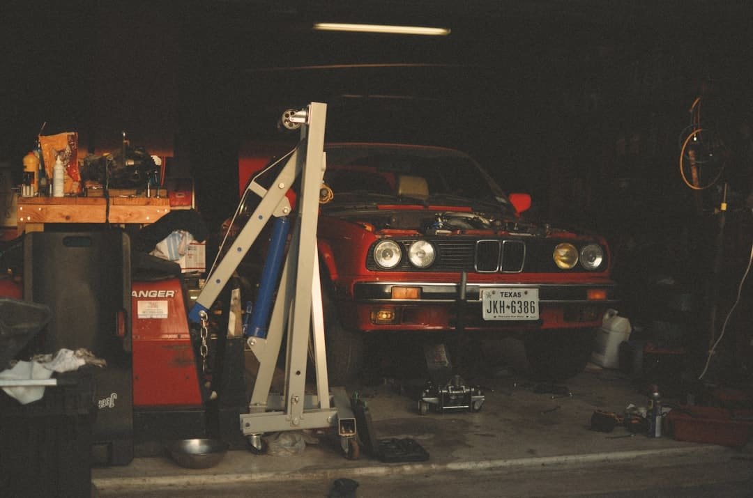 Engine hoist lift used to remove a used engine in a garage