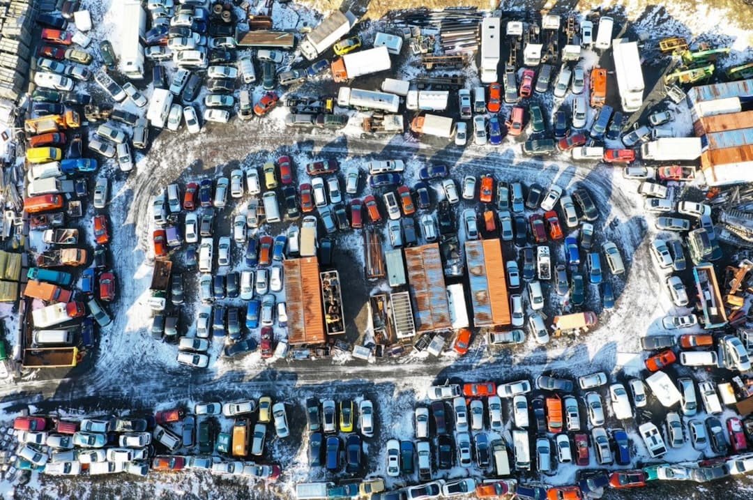 Wide view of rows of vehicles at an auto salvage yard
