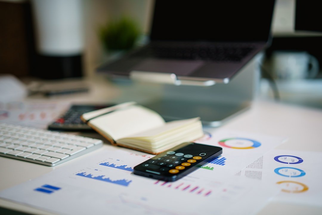 Calculating cost savings on a desk with charts and a calculator