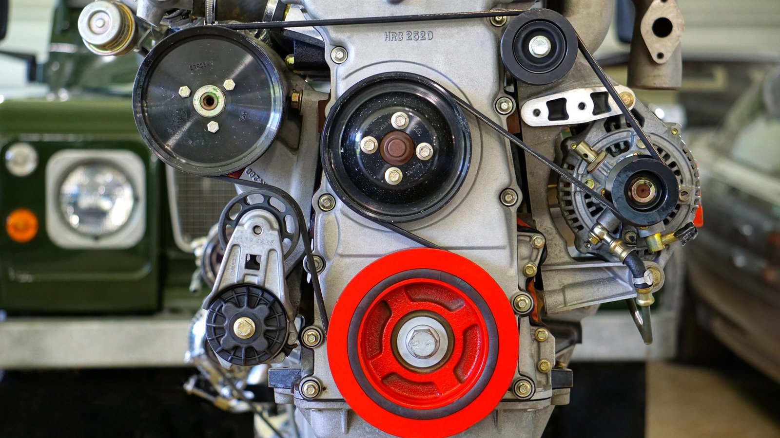 A drive belt and pulley system in a car engine bay