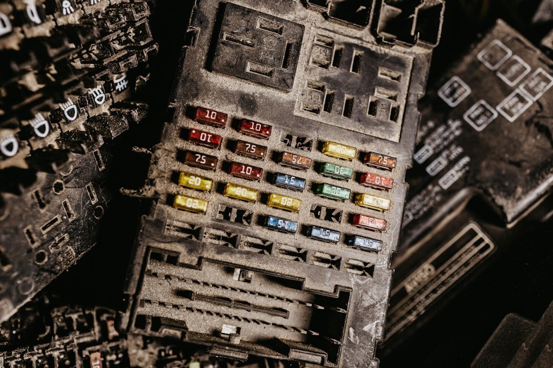An open fuse box and relay panel under the hood