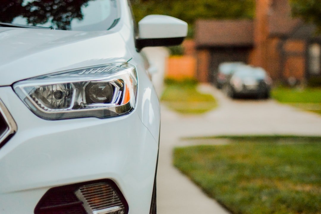 A car parked in a driveway in the evening
