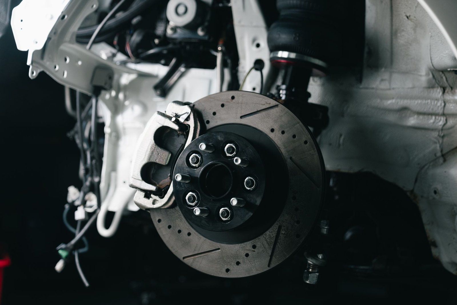 A car wheel removed exposing the hub and rotor