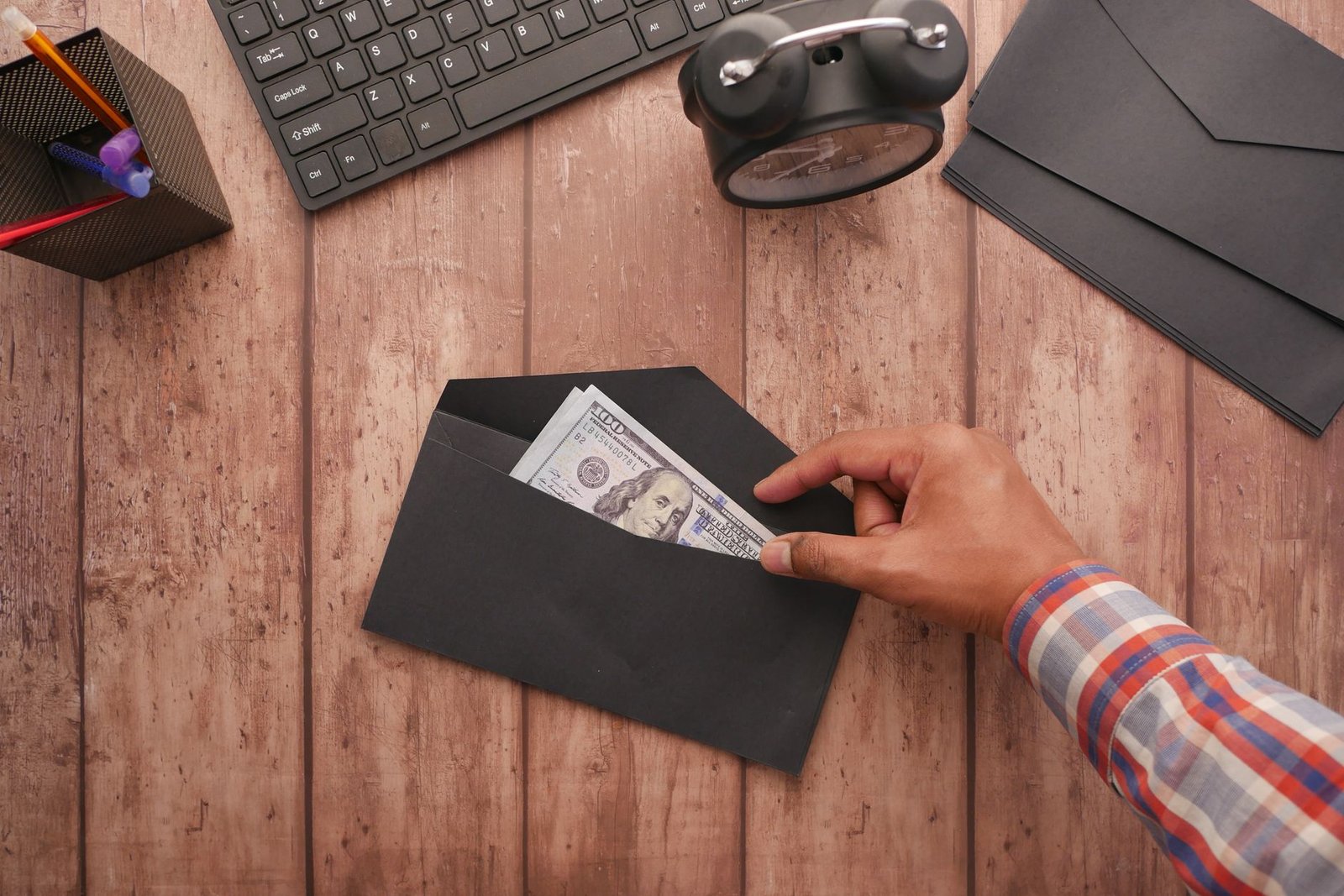 Cash payment being handed over from an envelope