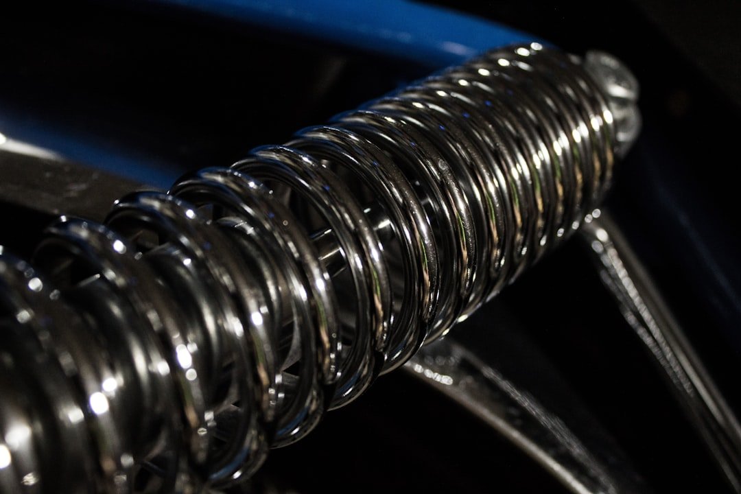 A coil spring and shock absorber shown for inspection