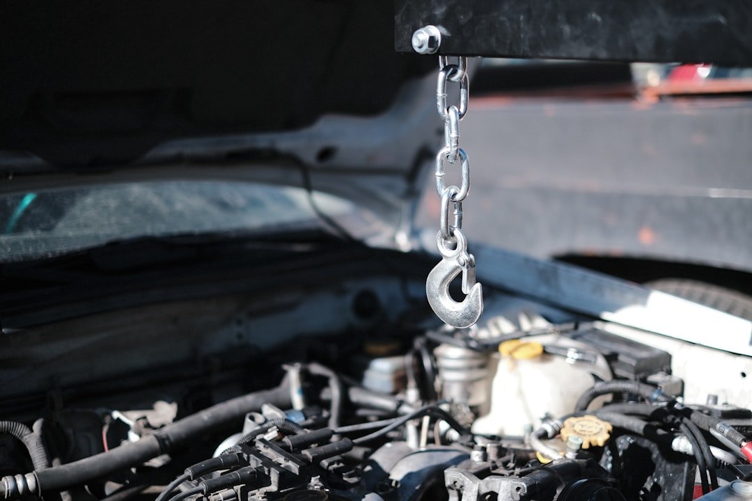 An engine hoist lifting a motor out of a vehicle
