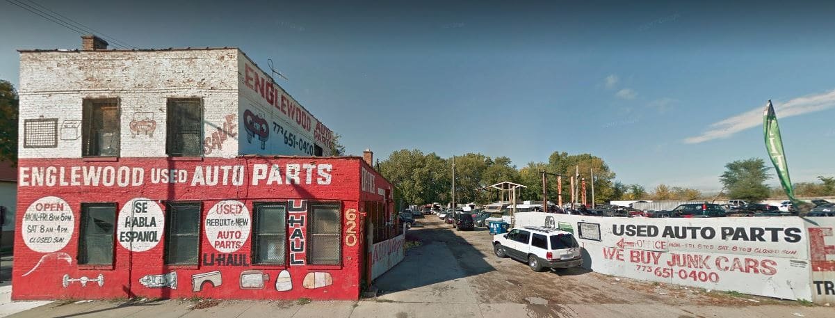 Street view of the Englewood Used Auto Parts salvage yard lot with used vehicles and inventory in Chicago
