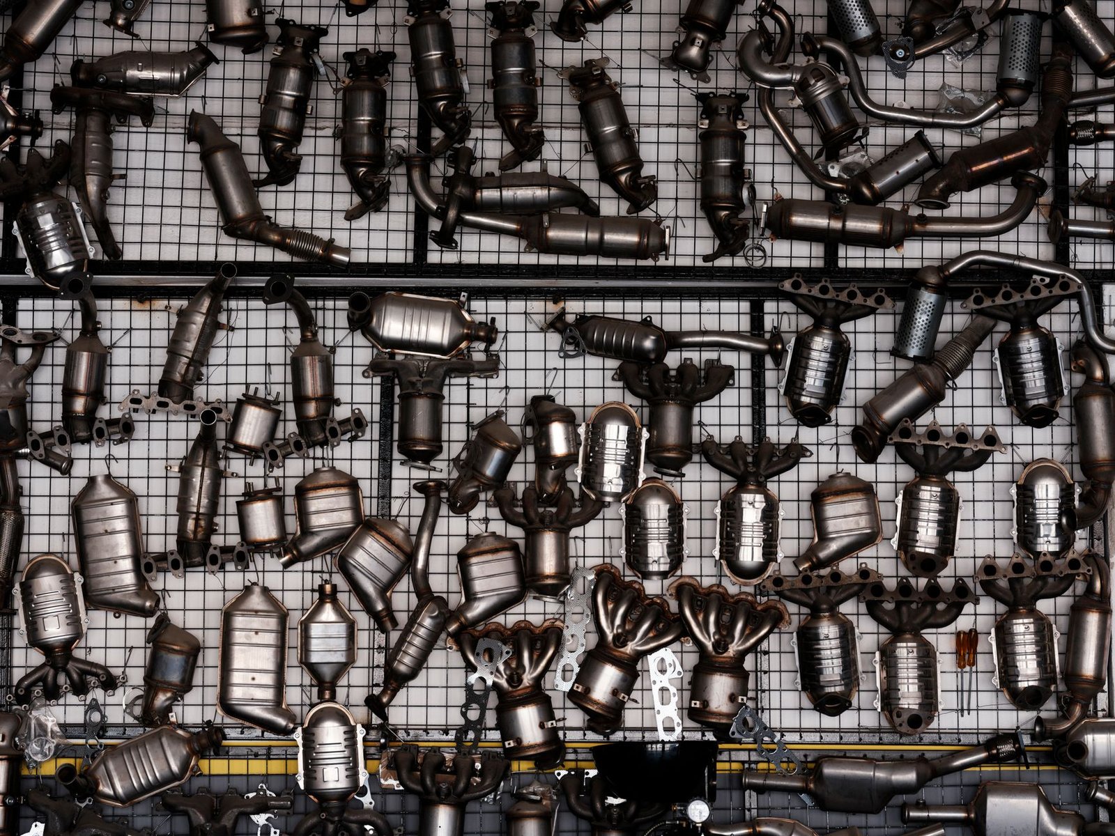 A wall of exhaust manifolds and catalytic converters