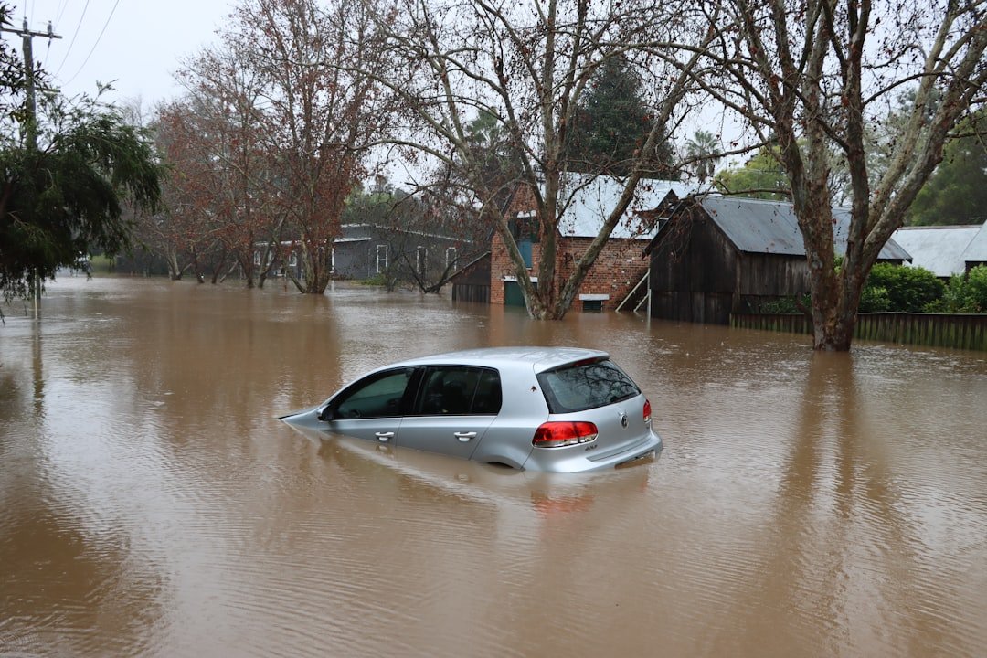 A car partially submerged on a flooded street