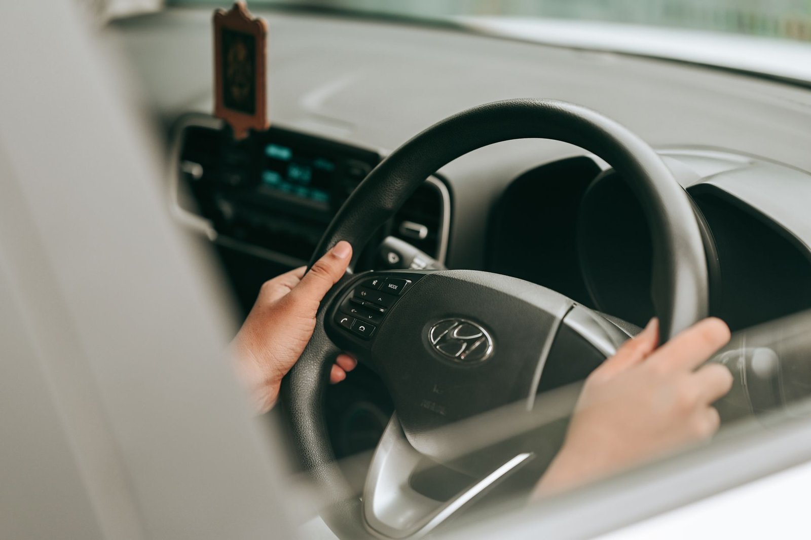 Hands on a car's steering wheel