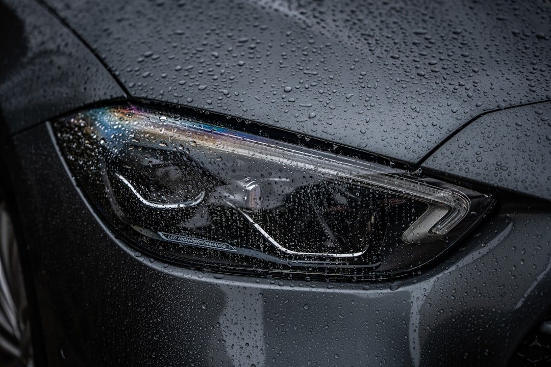 A headlight covered in raindrops