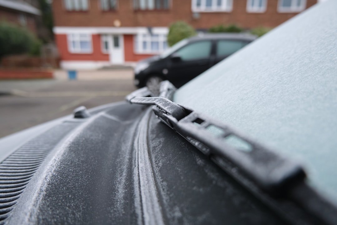 A frost-covered windshield in need of clearing