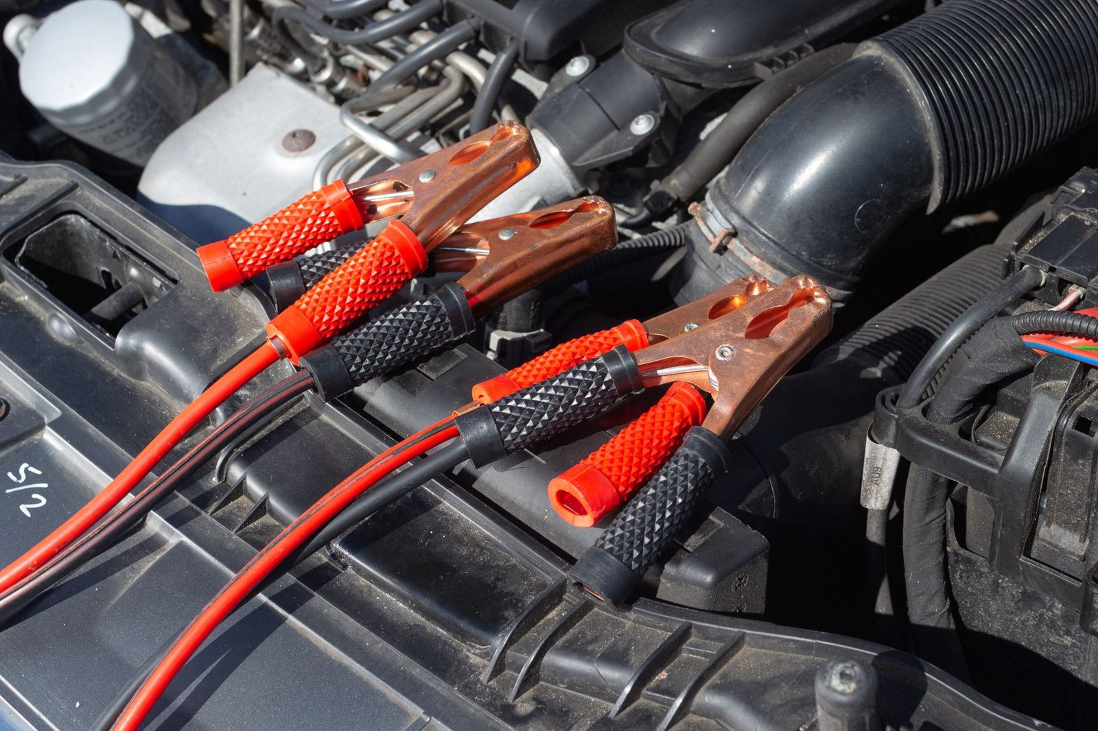 Jumper cable clamps in an engine bay