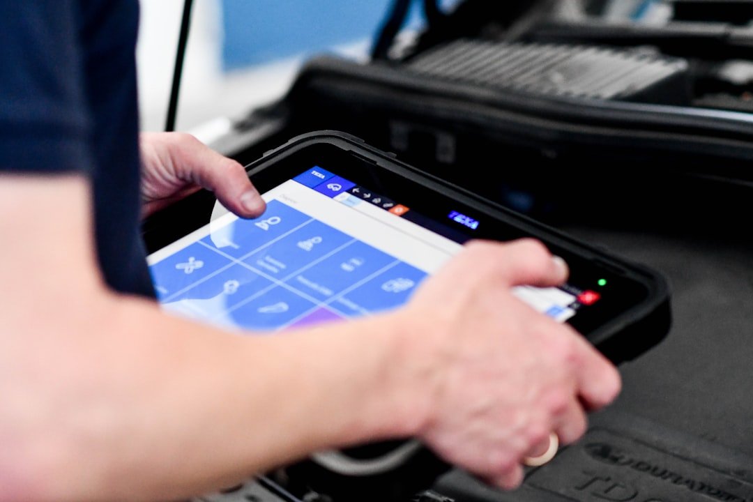 Mechanic using a diagnostic scanner on a vehicle