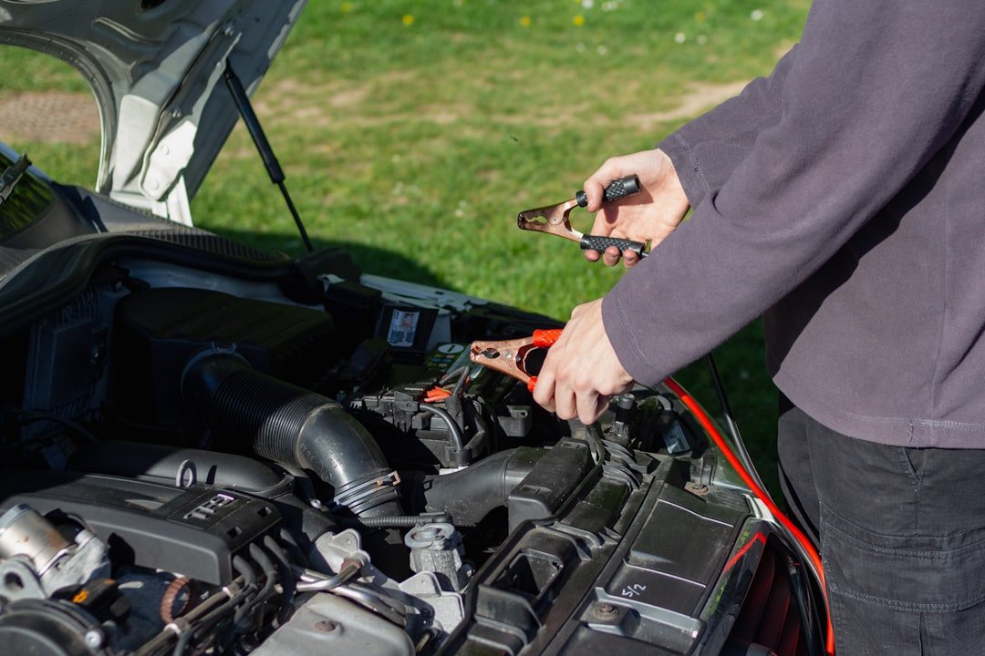 Attaching jumper cable clamps to a car battery terminal