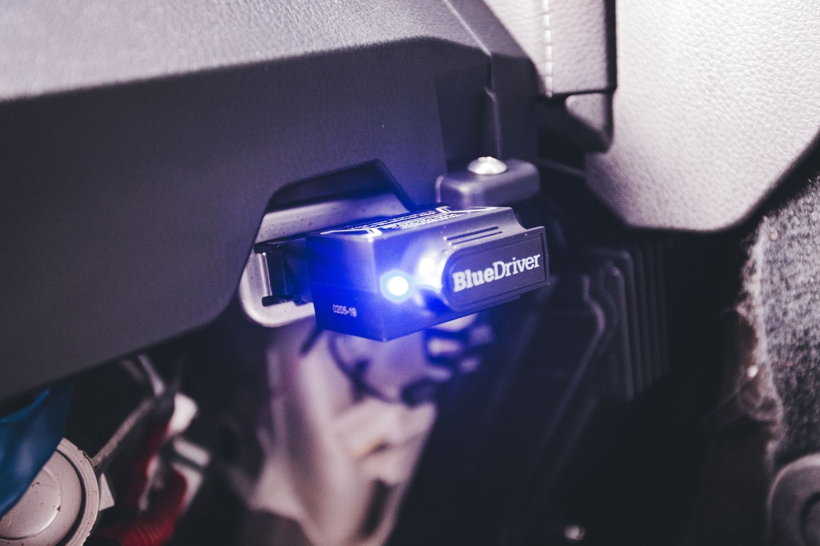 An OBD diagnostic scanner plugged into a vehicle
