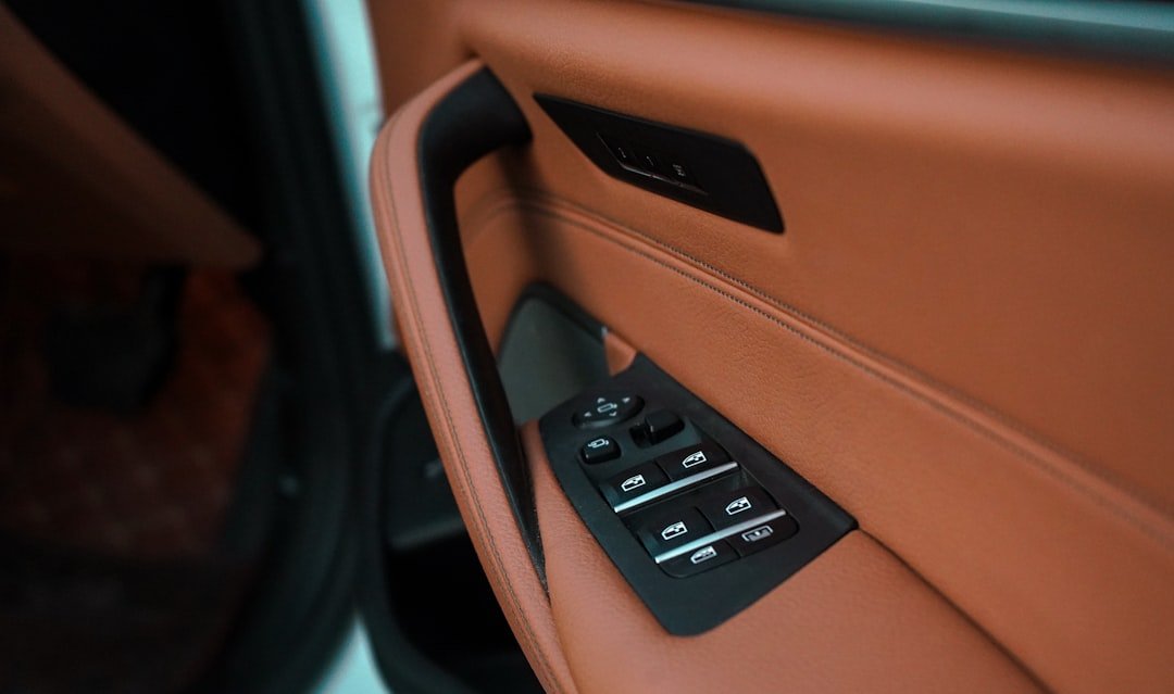 A power window and mirror switch panel on a car door