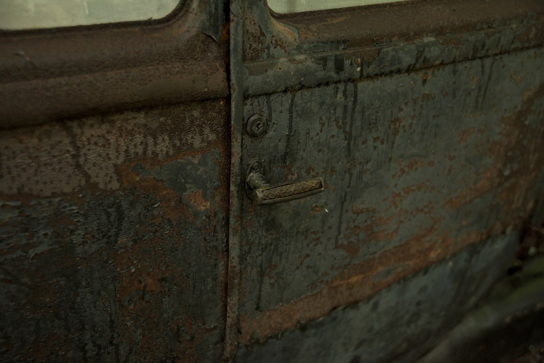 Rust and peeling paint on a vintage car door