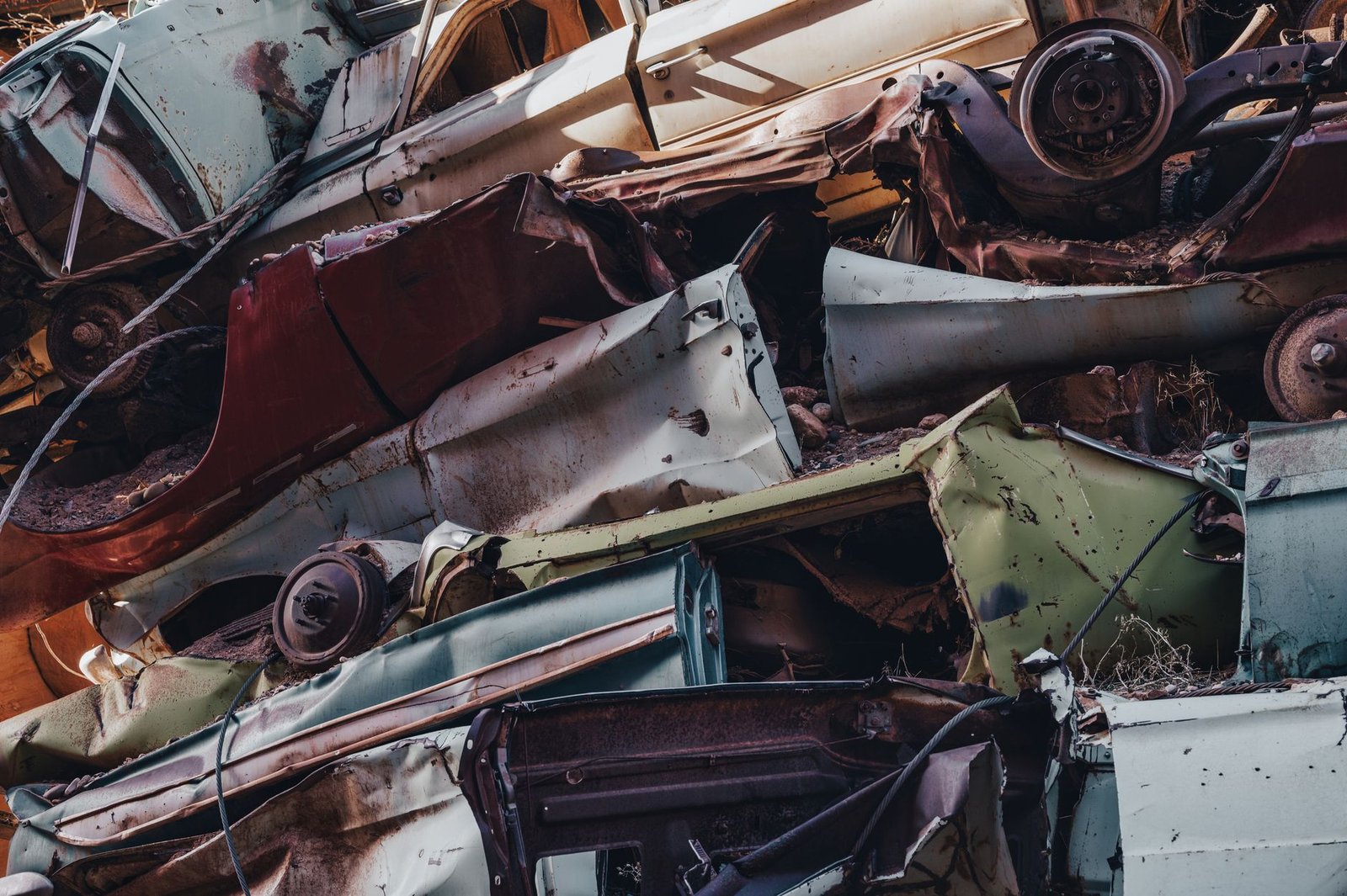 A pile of rusty scrapped car parts