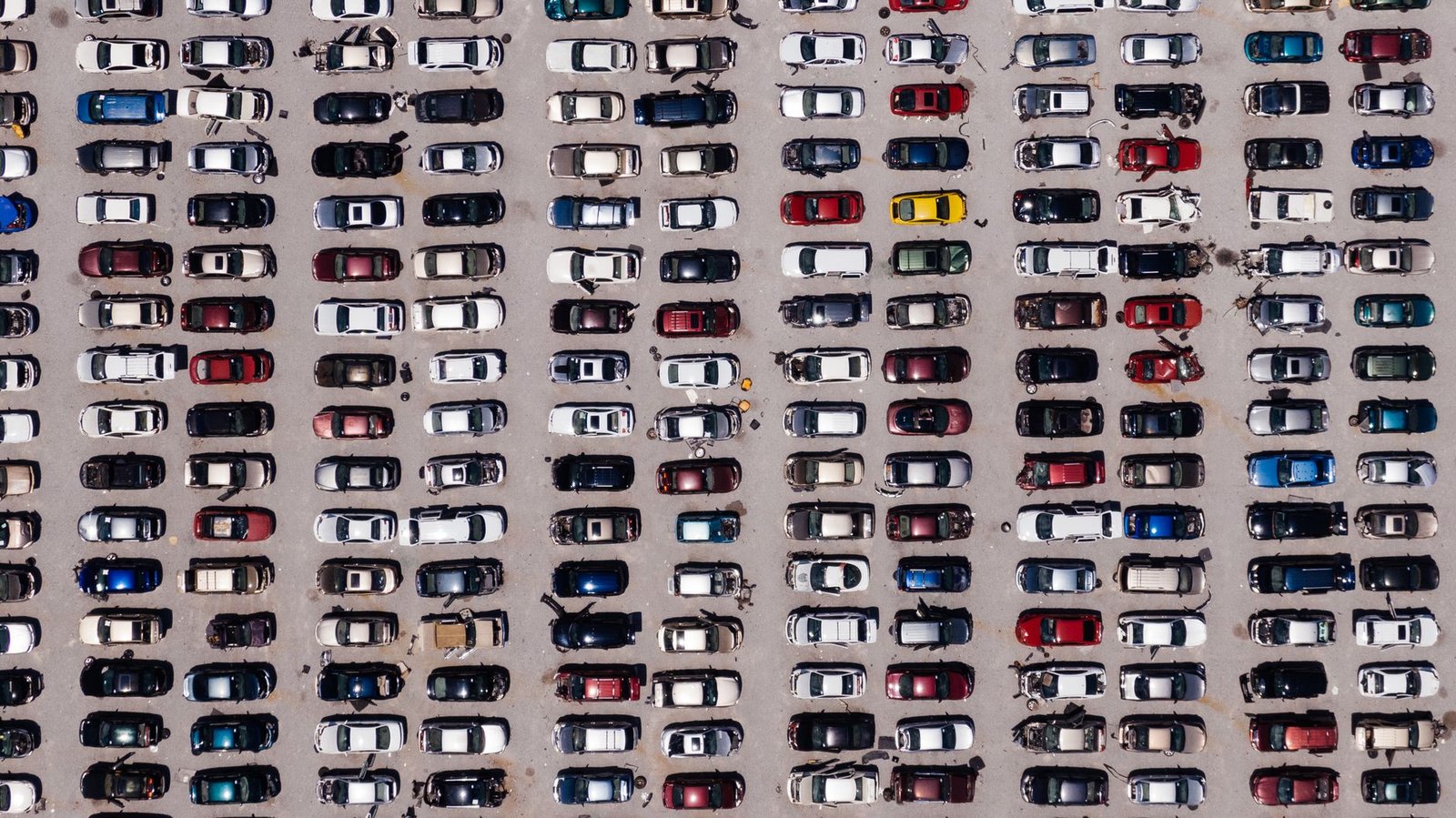 Aerial view of rows of vehicles in a salvage yard