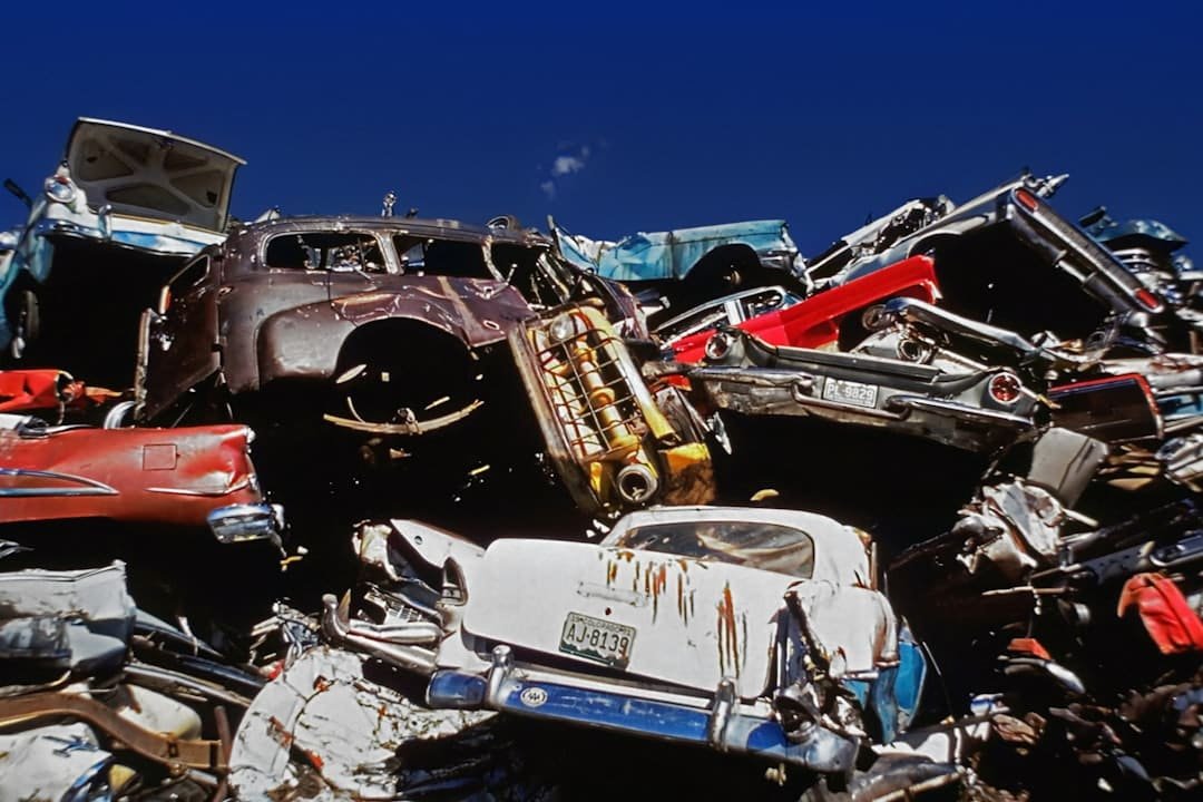 Stacked scrap vehicles at an automotive salvage yard
