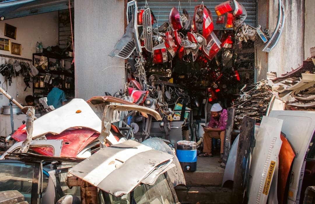 Stacked used automotive bumpers and body parts
