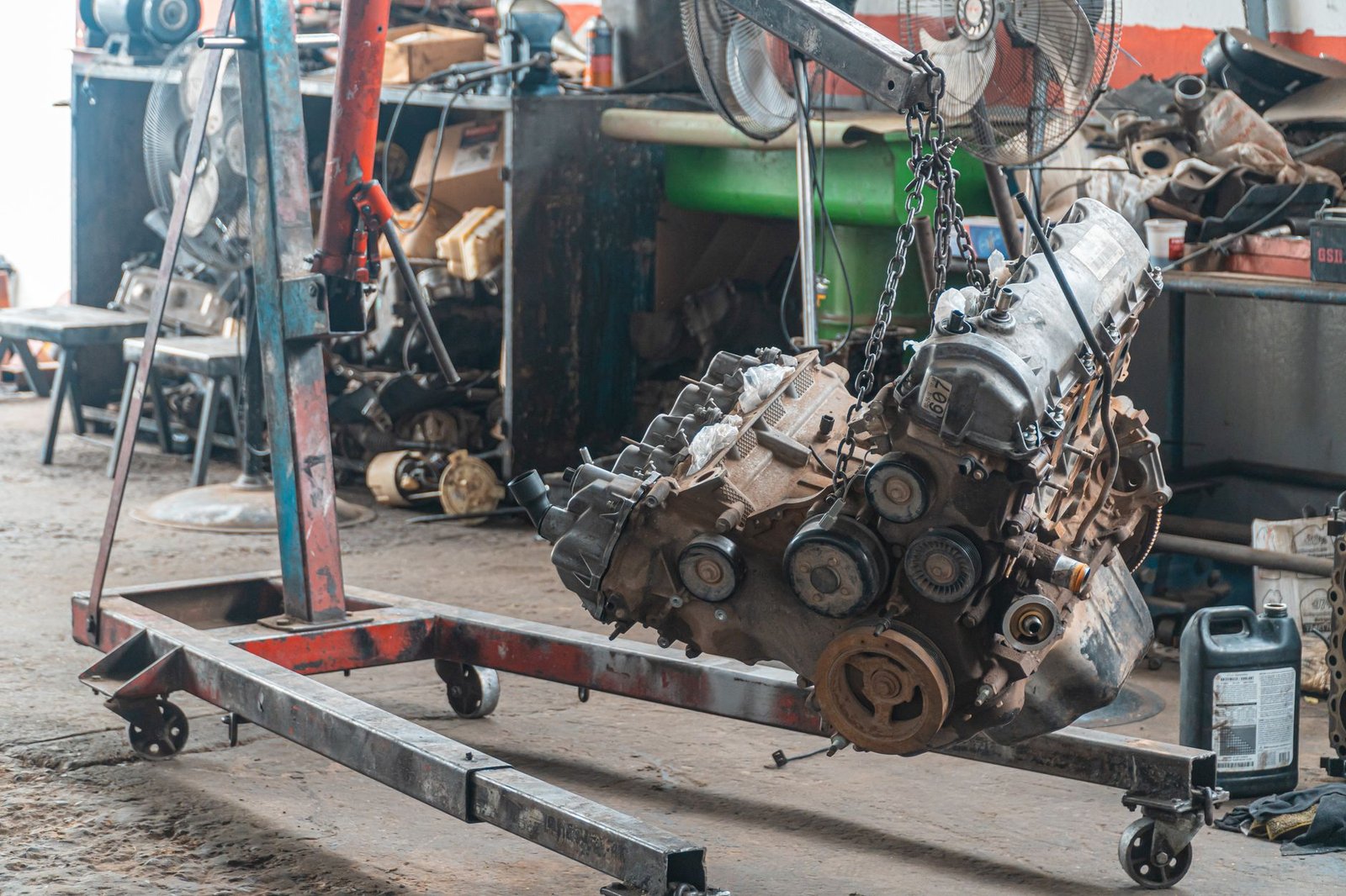 A used engine block on a hoist stand