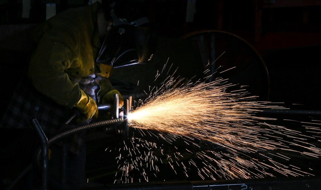 Welding an exhaust pipe in a shop